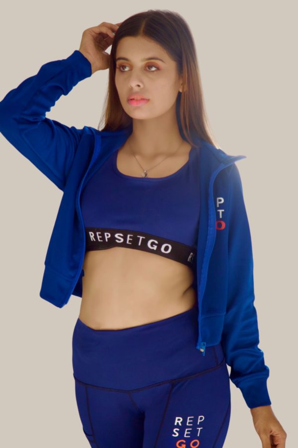 woman wearing criss cross repset-go navy blue sports bra front angle