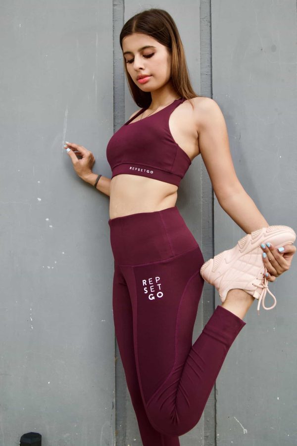 woman wearing repset-go plum tights stretching-